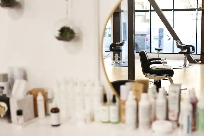 A styling chair beside a mirror.