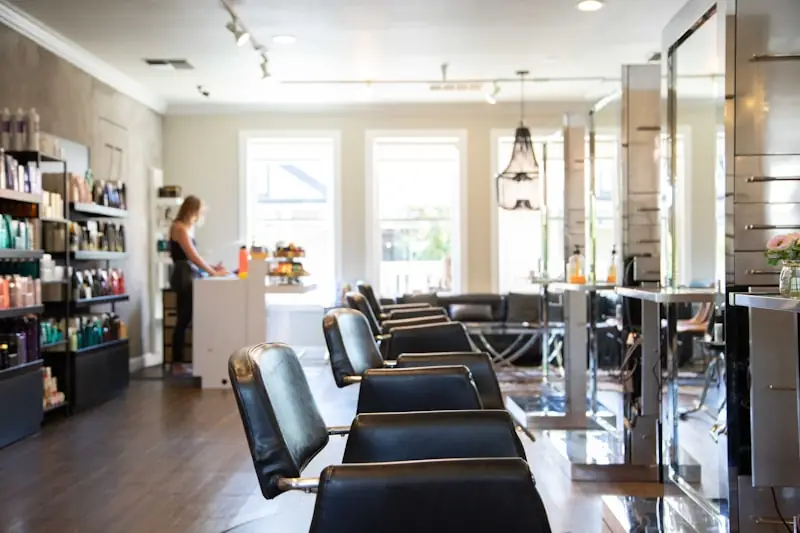A stylist's station with leather chairs.